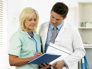 Nurse and doctor reviewing report.